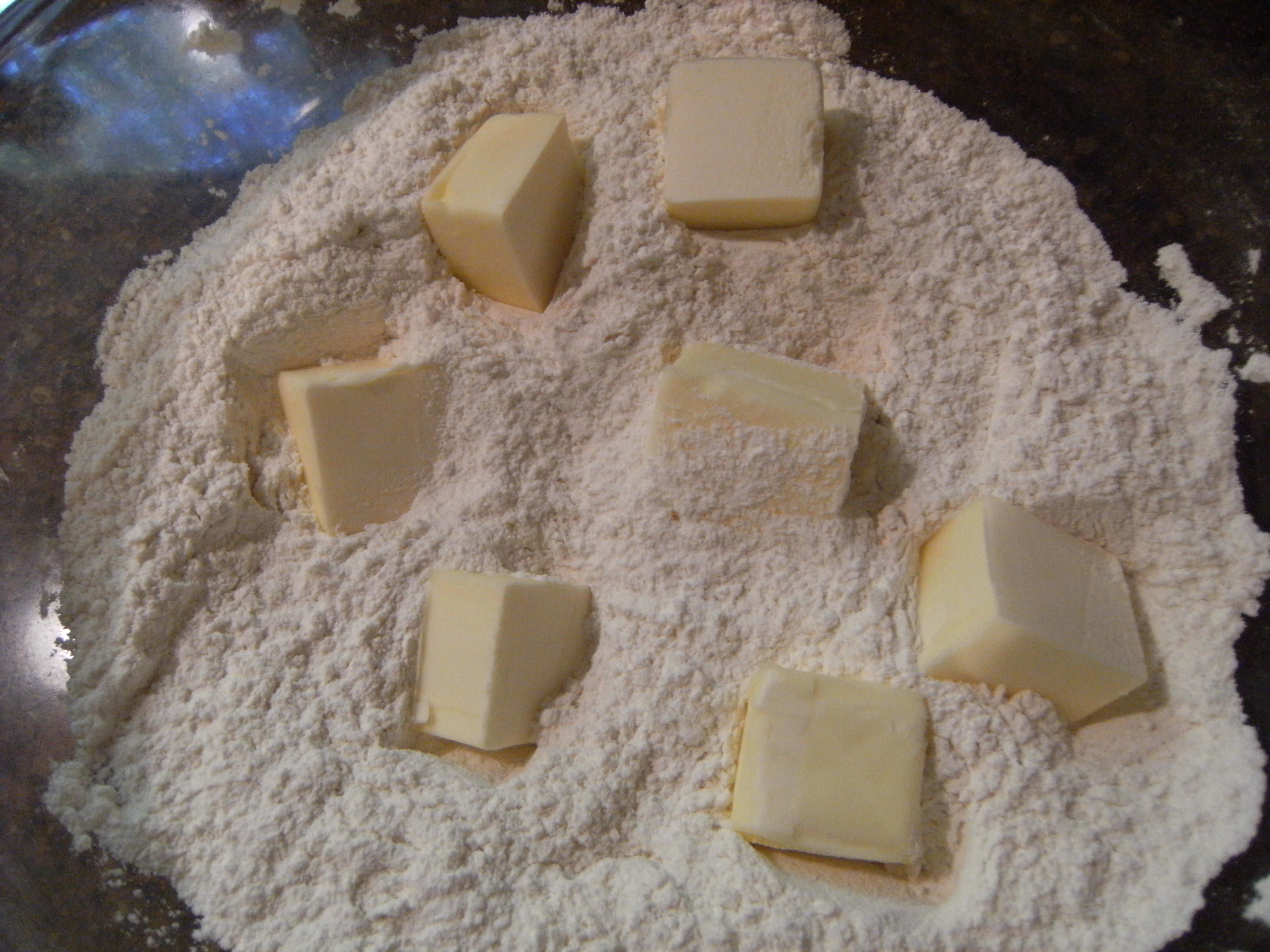 incorporating butter into dry ingredients for homemade biscuits