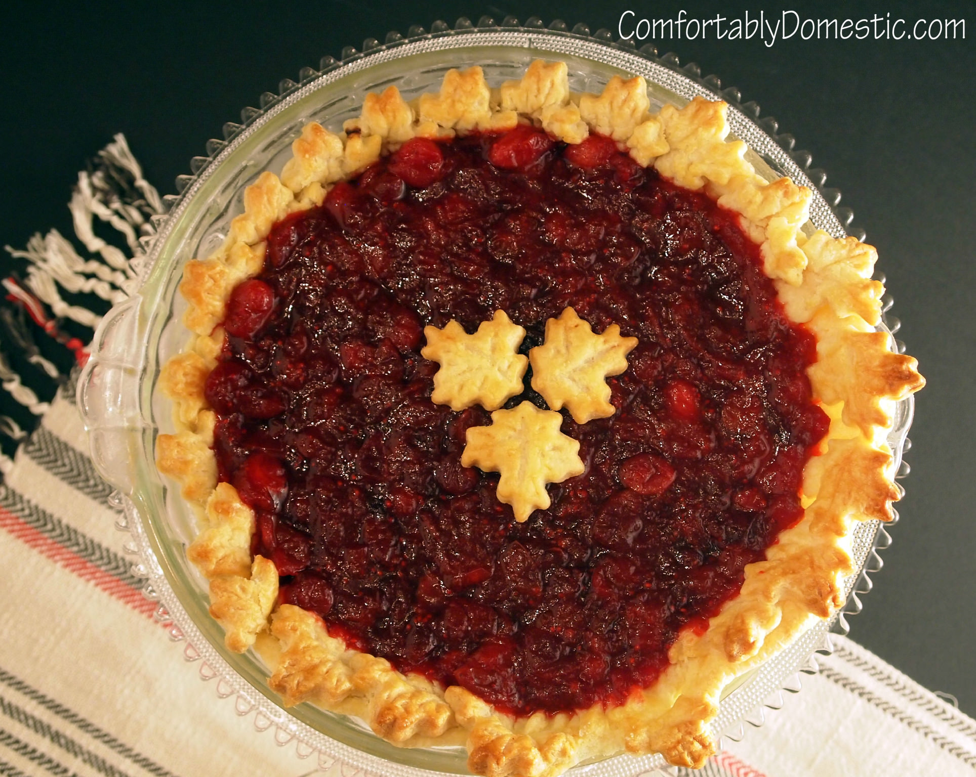 Dark chocolate cranberry pie may become your new favorite holiday pie recipe! Dark chocolate pie, topped with tart, fresh cranberry sauce, all baked into a flaky pie crust. | ComfortablyDomestic.com