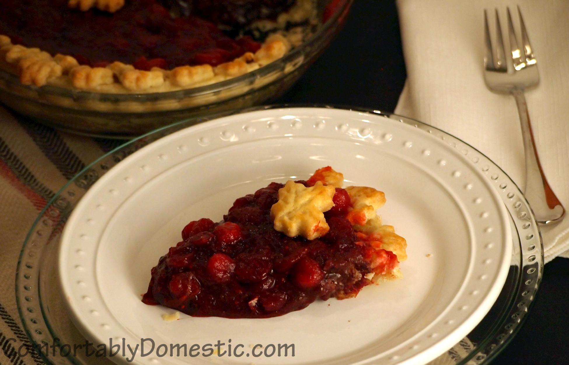 Dark chocolate cranberry pie may become your new favorite holiday pie recipe! Dark chocolate pie, topped with tart, fresh cranberry sauce, all baked into a flaky pie crust.
