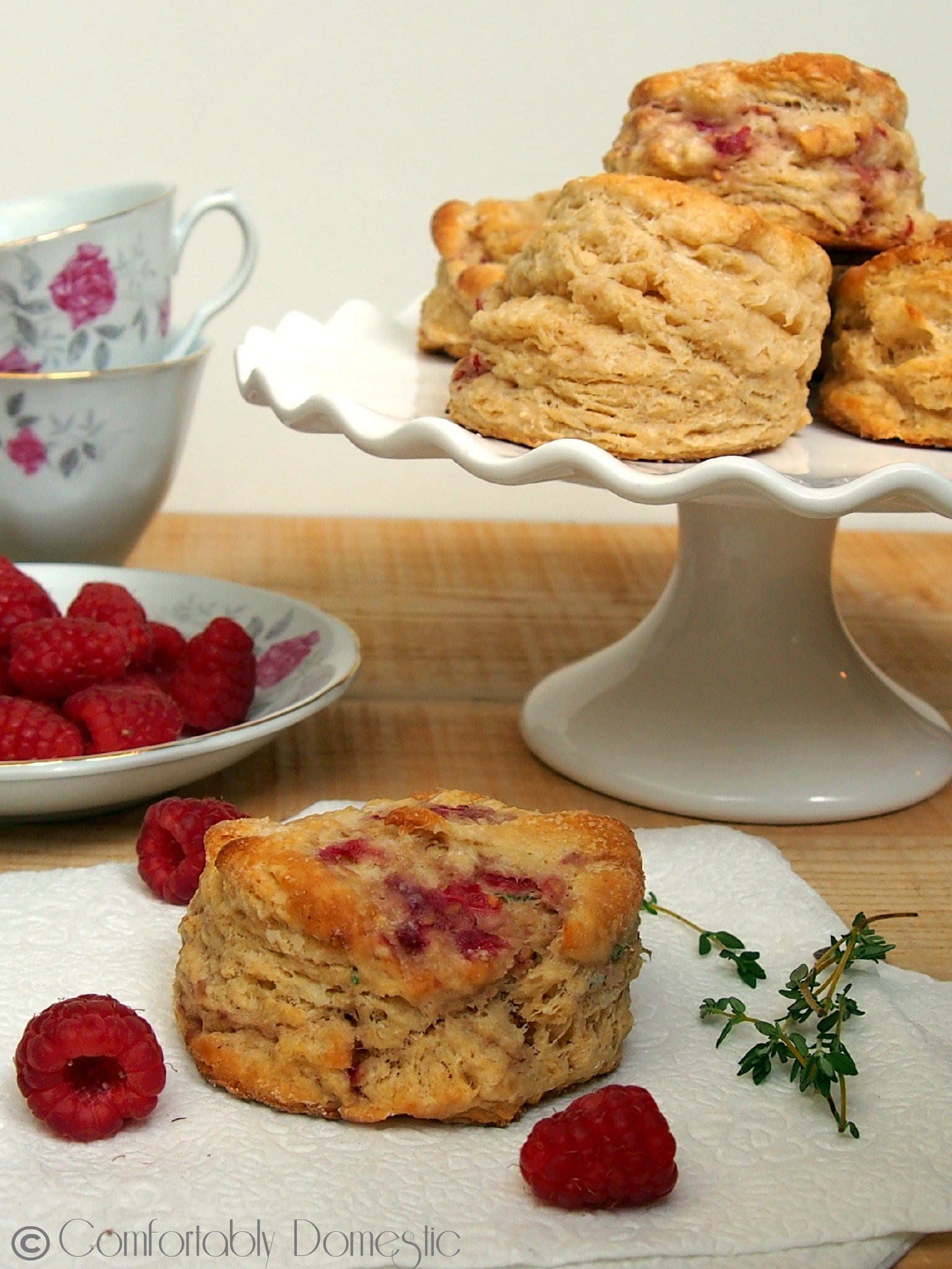 Raspberry thyme goat cheese biscuits are the perfect treat with a hot cup of coffee or afternoon tea. Tender and flaky, with just the right touch of raspberry sweetness to compliment the thyme and creamy goat cheese. | ComfortablyDomestic.com