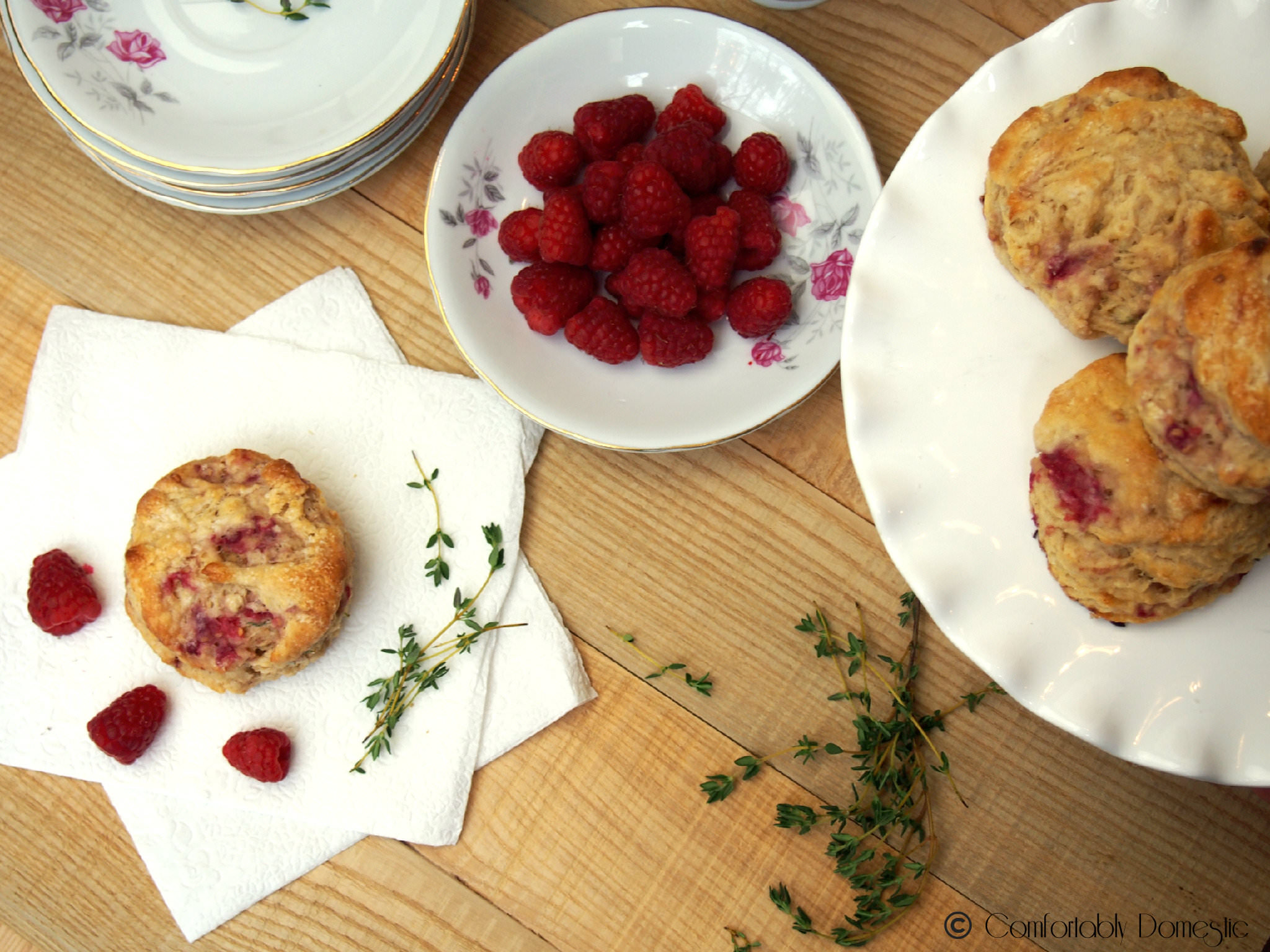 Raspberry thyme goat cheese biscuits are the perfect treat with a hot cup of coffee or afternoon tea. Tender and flaky, with just the right touch of raspberry sweetness to compliment the thyme and creamy goat cheese. | ComfortablyDomestic.com