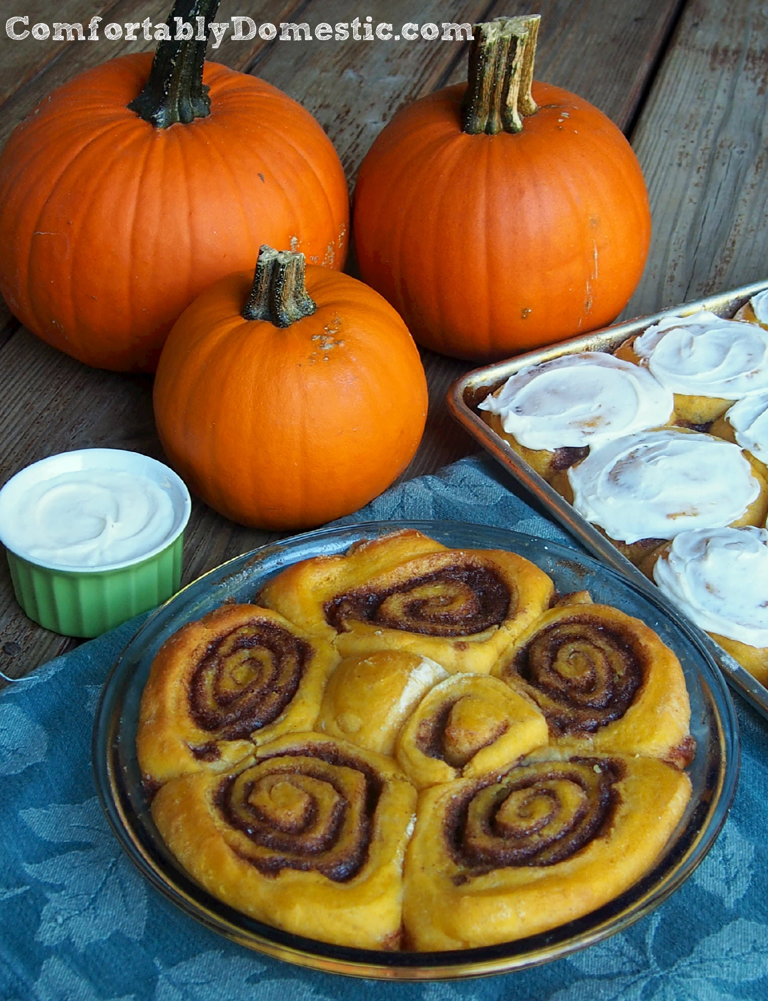 Pumpkin cinnamon rolls usher in the cool comfort of autumn any time of the year. Piping hot, and just dripping with cream cheese icing. | ComfortablyDomestic.com
